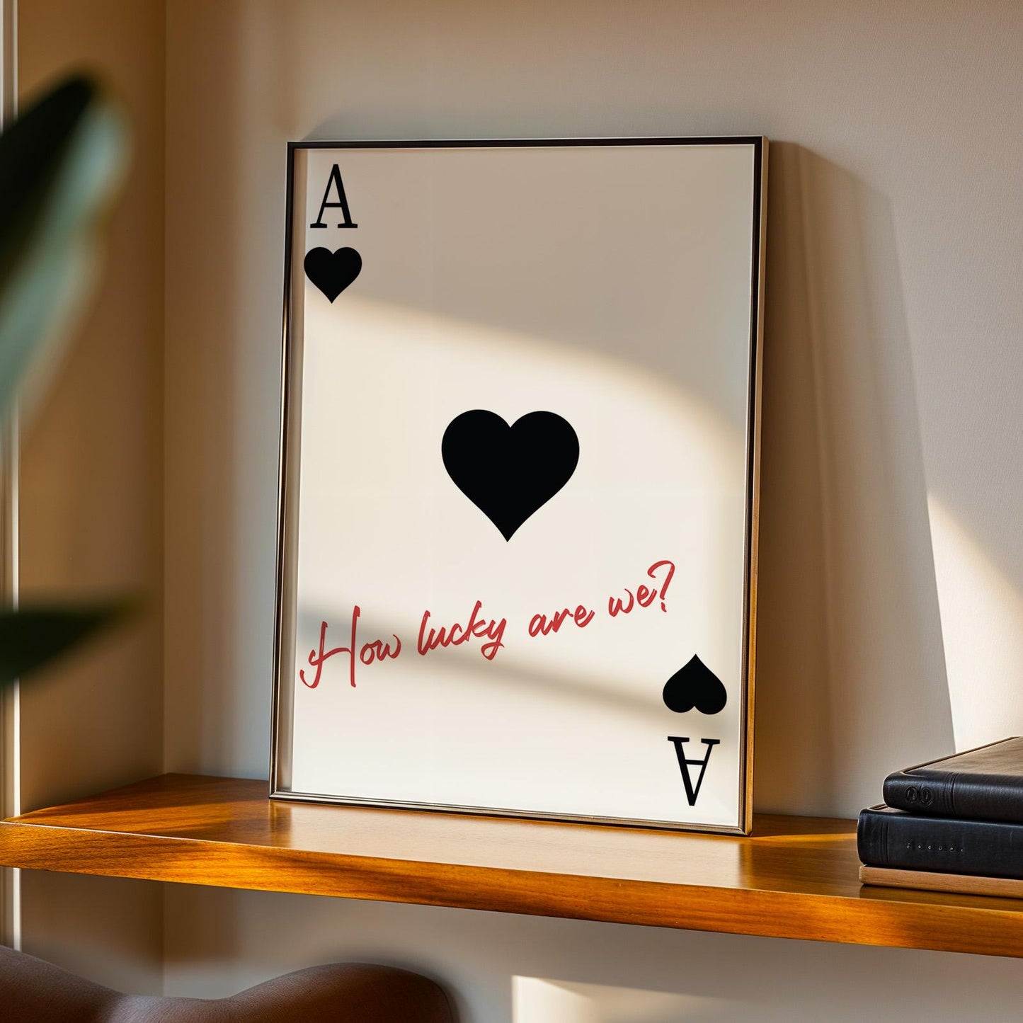 Western-style black poster with black hearts and red handwritten lyric leaning casually on a rustic wooden counter