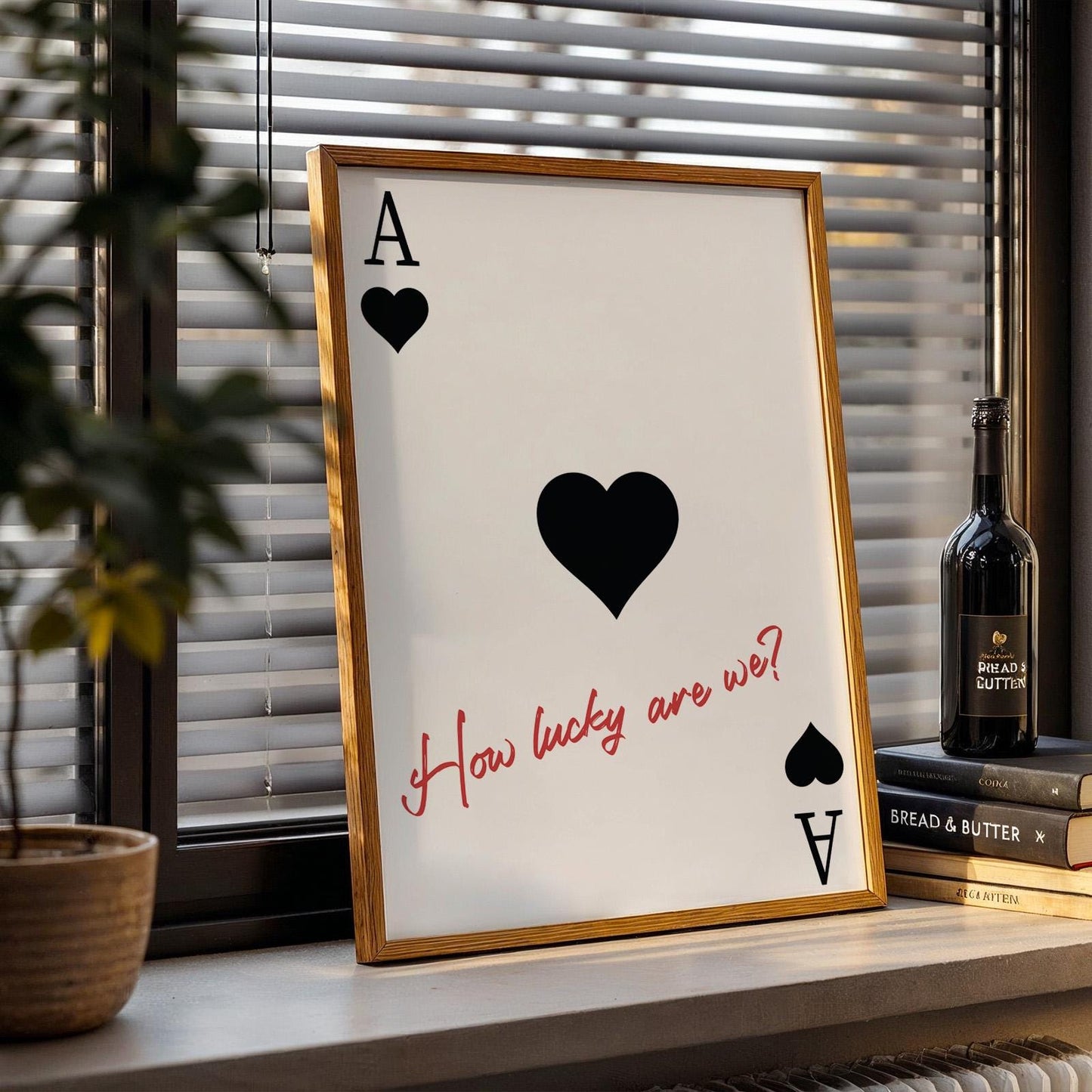 Framed black Western poster leaning on a counter with red handwritten love lyric and subtle black heart design