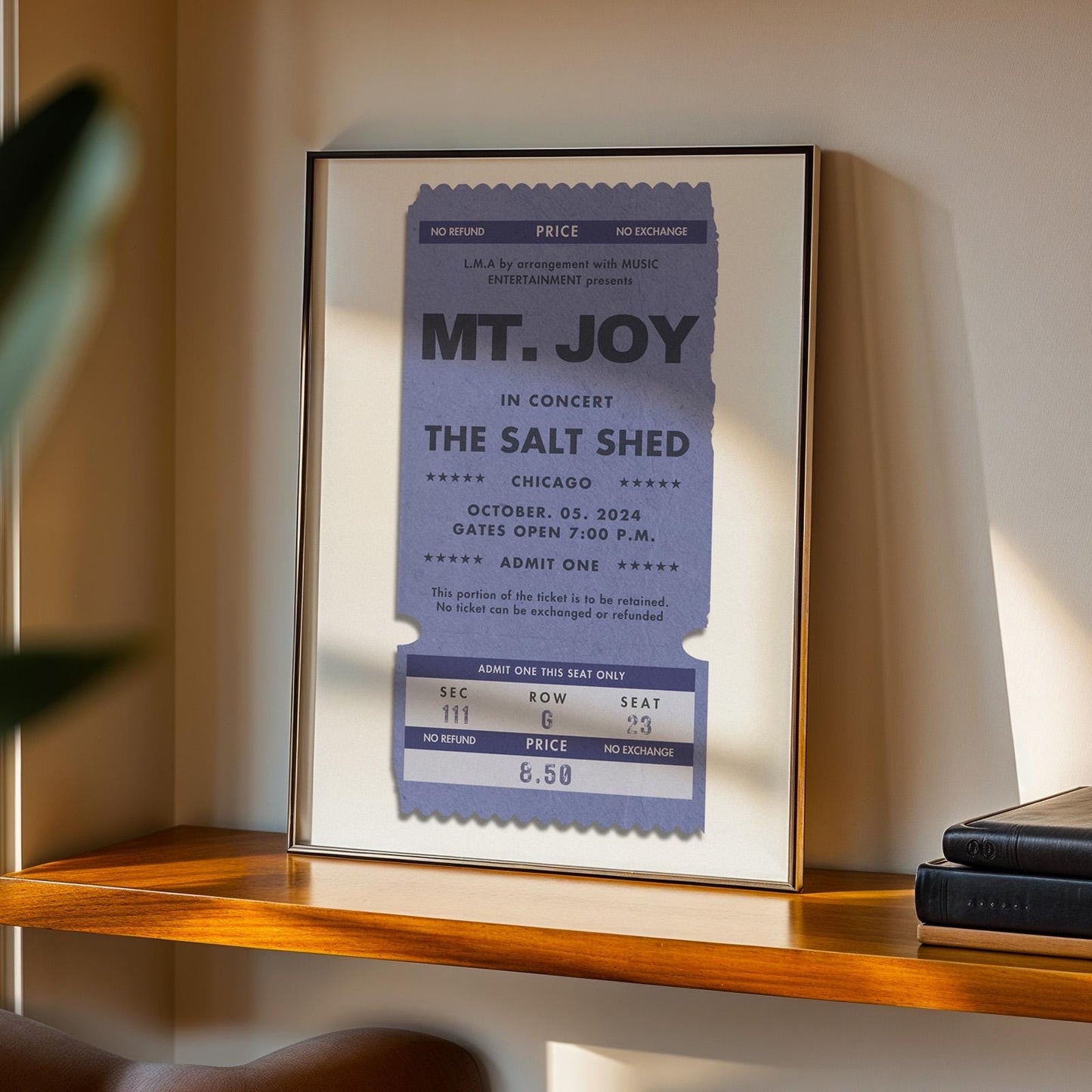 Bespoke single band artist stub print in vintage colour, framed poster leaning on wall, thoughtful gift idea.