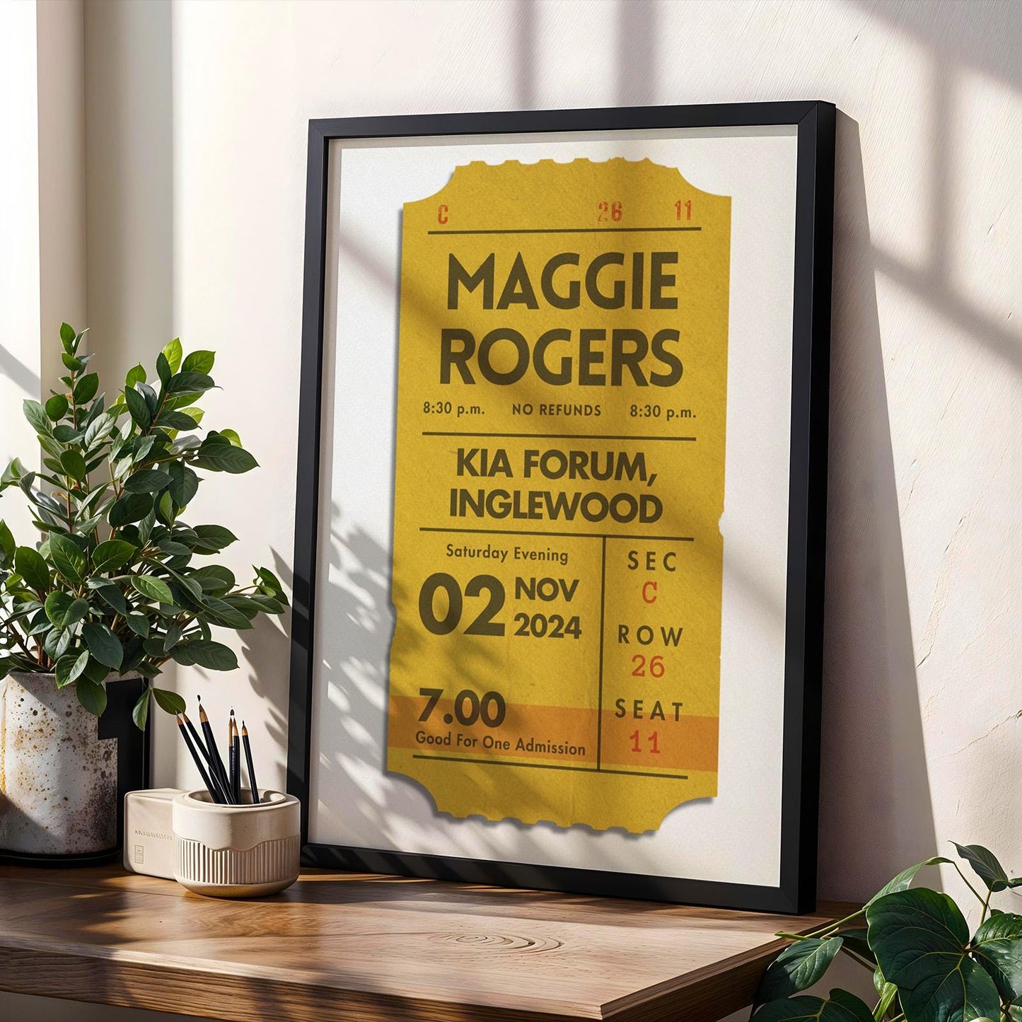 Framed personalised concert ticket set, bundle of 3 colours for shelf. Item leaning on wall in office.