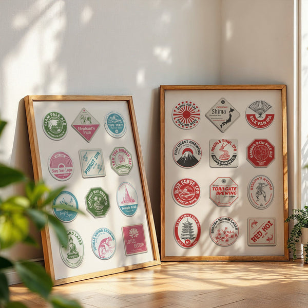 A minimalist apartment with white walls. Two framed art prints are on the floor showing art with vintage beer mat designs on a poster for different travel destinations such as japan and thailand.