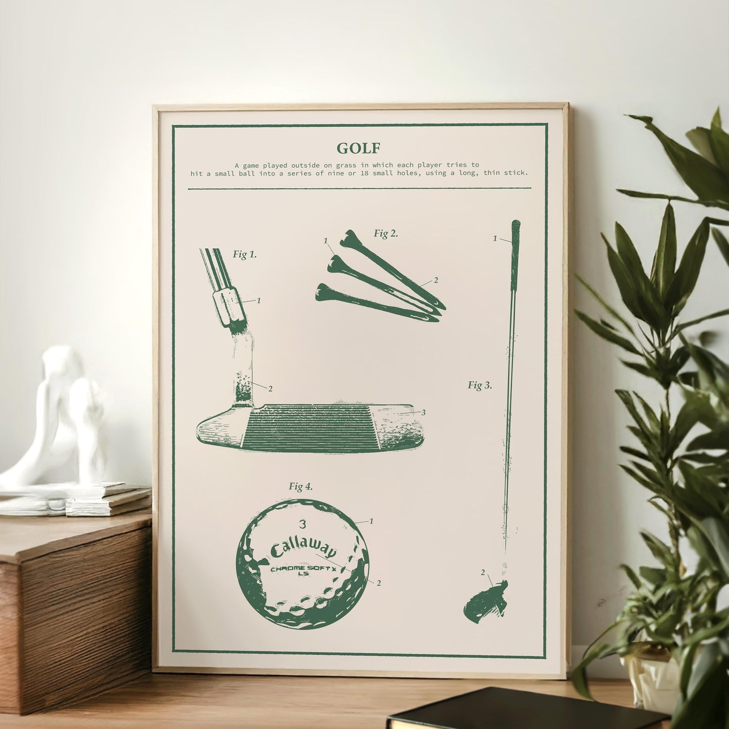 Rustic golf patent blueprint print framed and leaning on wooden surface, showcasing detailed clubs, ball, and tee diagram.