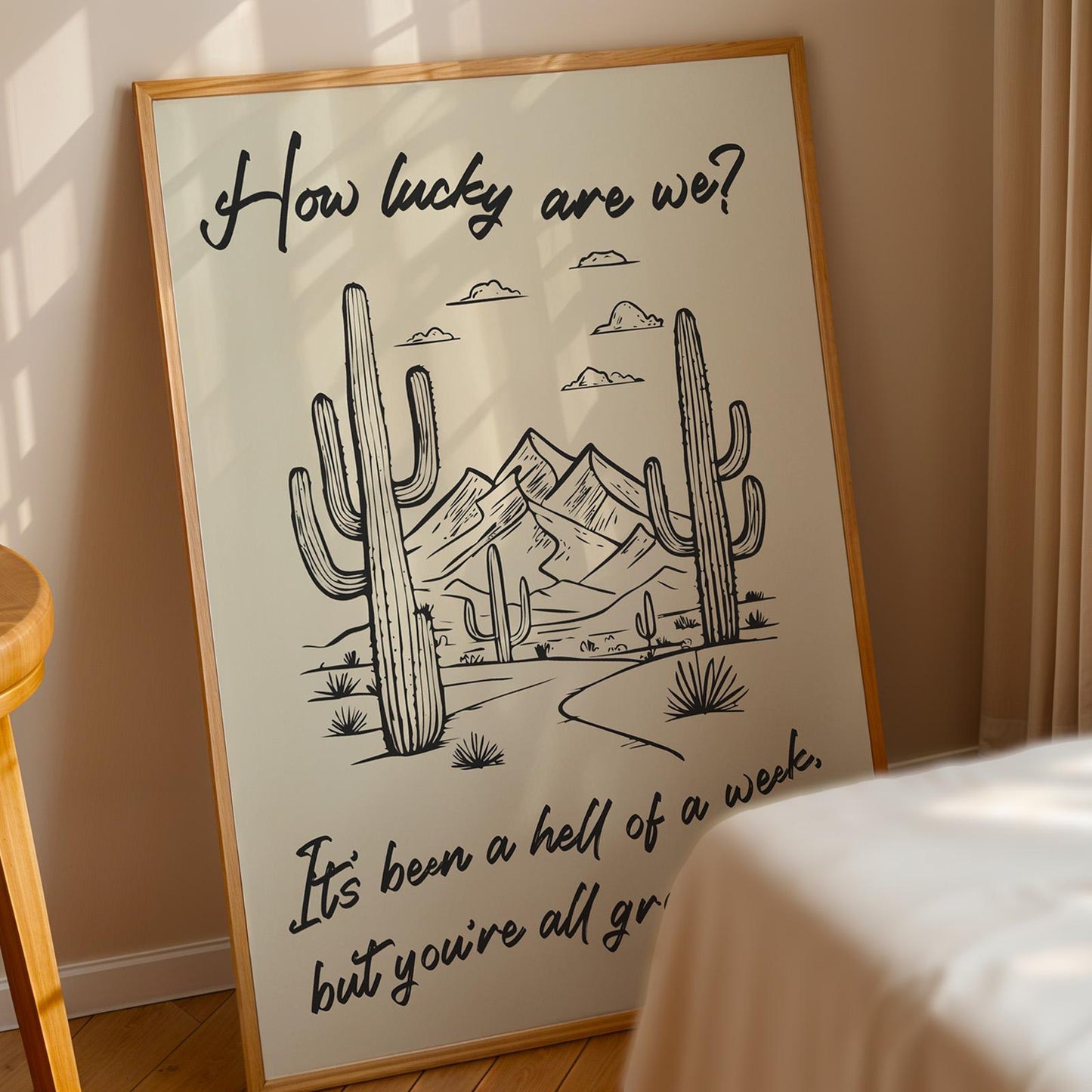 Western lyric art print In bedroom featuring desert scenery and “how lucky are we?” phrase, great gift for country lovers.