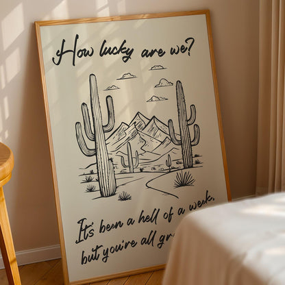 Western lyric art print In bedroom featuring desert scenery and “how lucky are we?” phrase, great gift for country lovers.