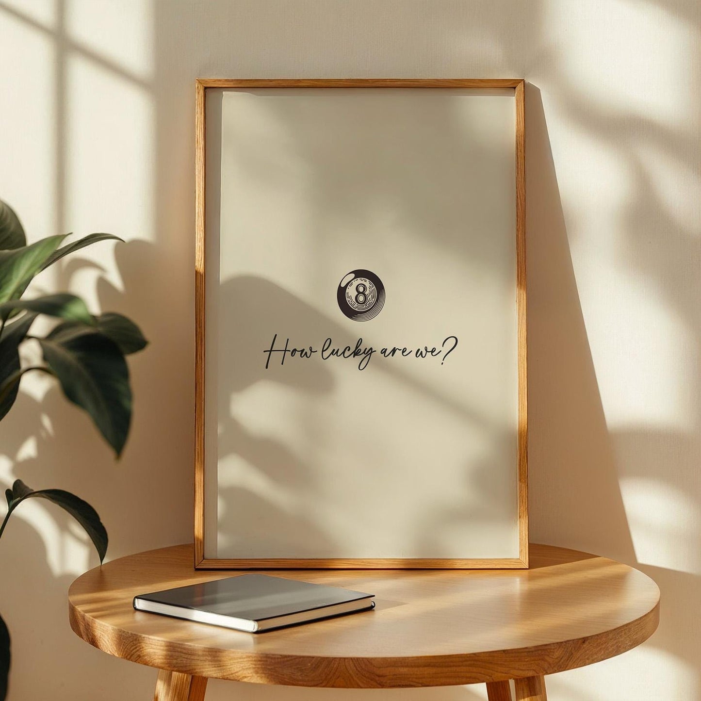 How lucky are we lyric poster with minimalist ball design, leaning framed on a living room console.