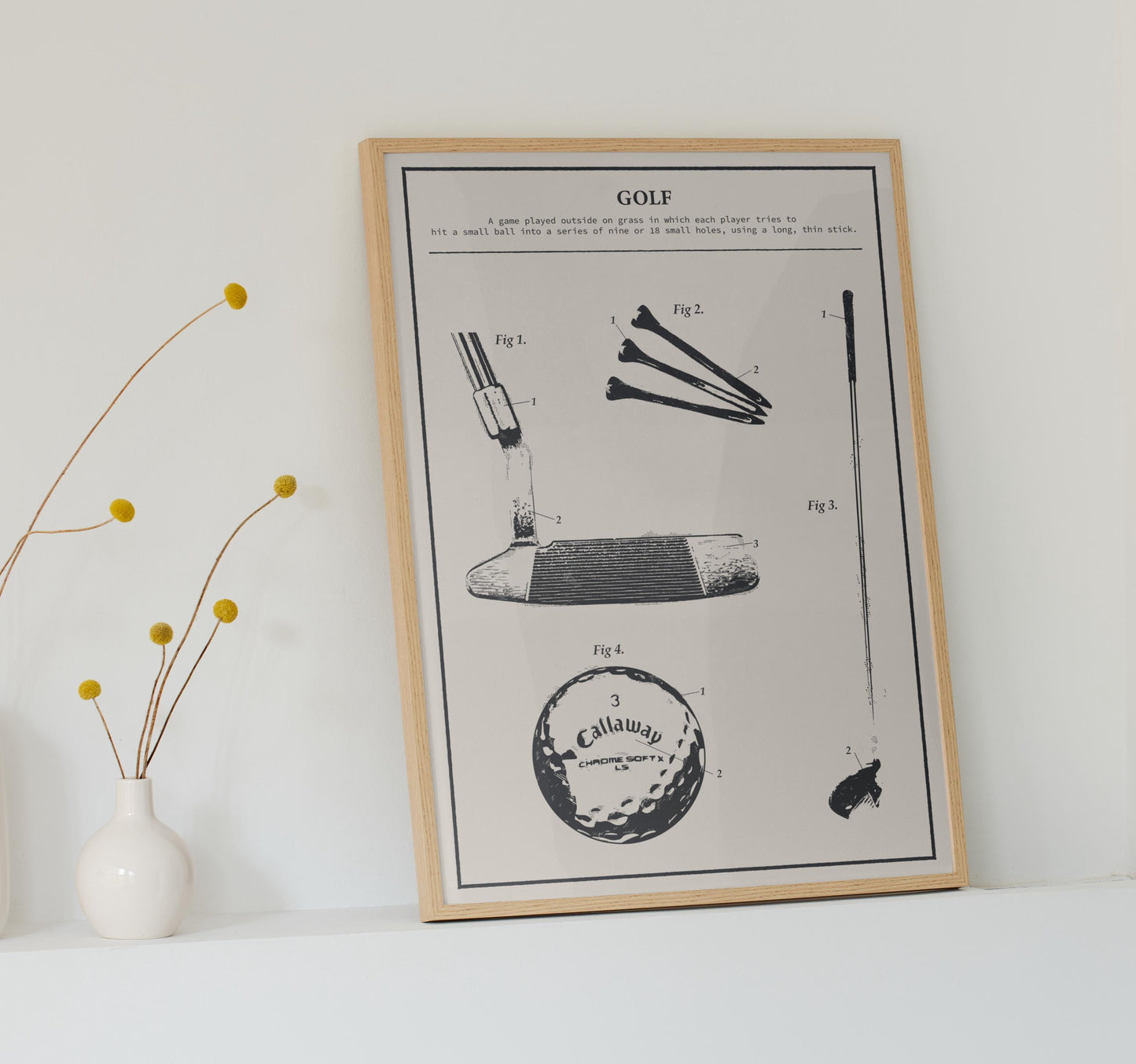 Framed rustic golf patent poster leaning on countertop, featuring detailed golf club, ball, and tee illustration in classic black and white.