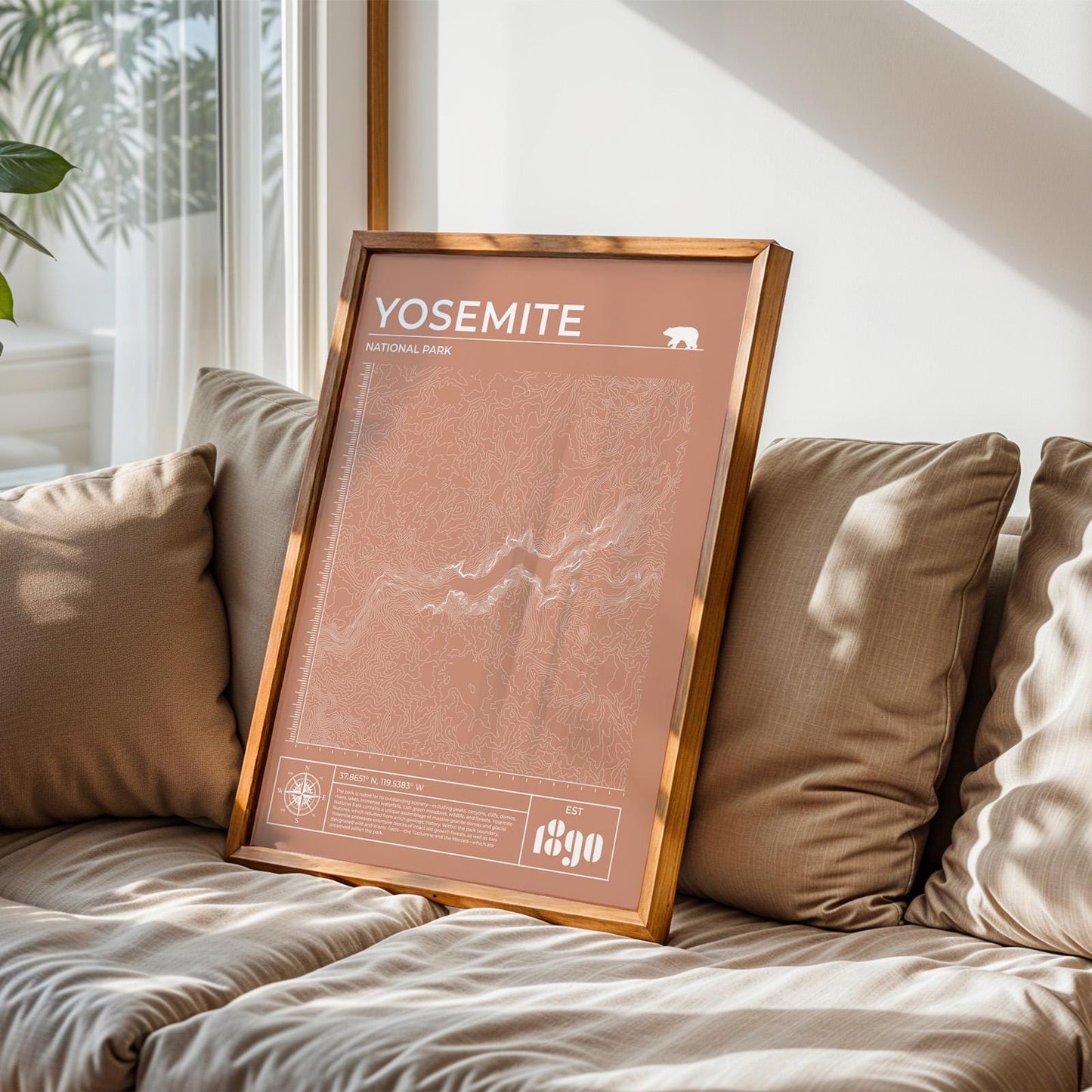 Rustic Yosemite topographic print framed, perfect nature and camping gift, leaning on sofa.