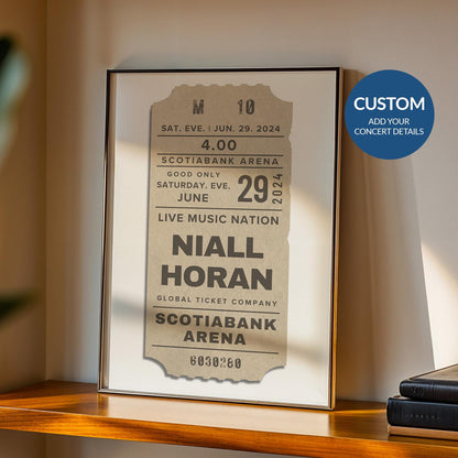 Framed beige concert ticket poster, personalised vintage print leaning on a shelf, nostalgic music gift.