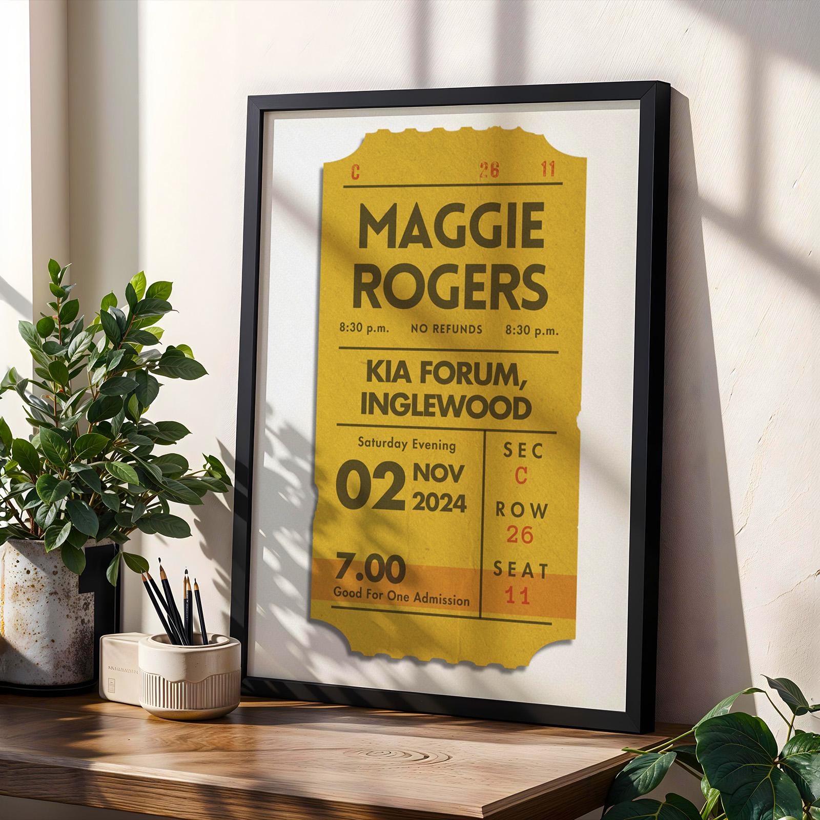 Framed personalised concert ticket set, bundle of 3 colours for shelf. Item leaning on wall in office.