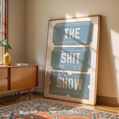 Blue worn ticket stub art with funny phrase on it. in living room by window