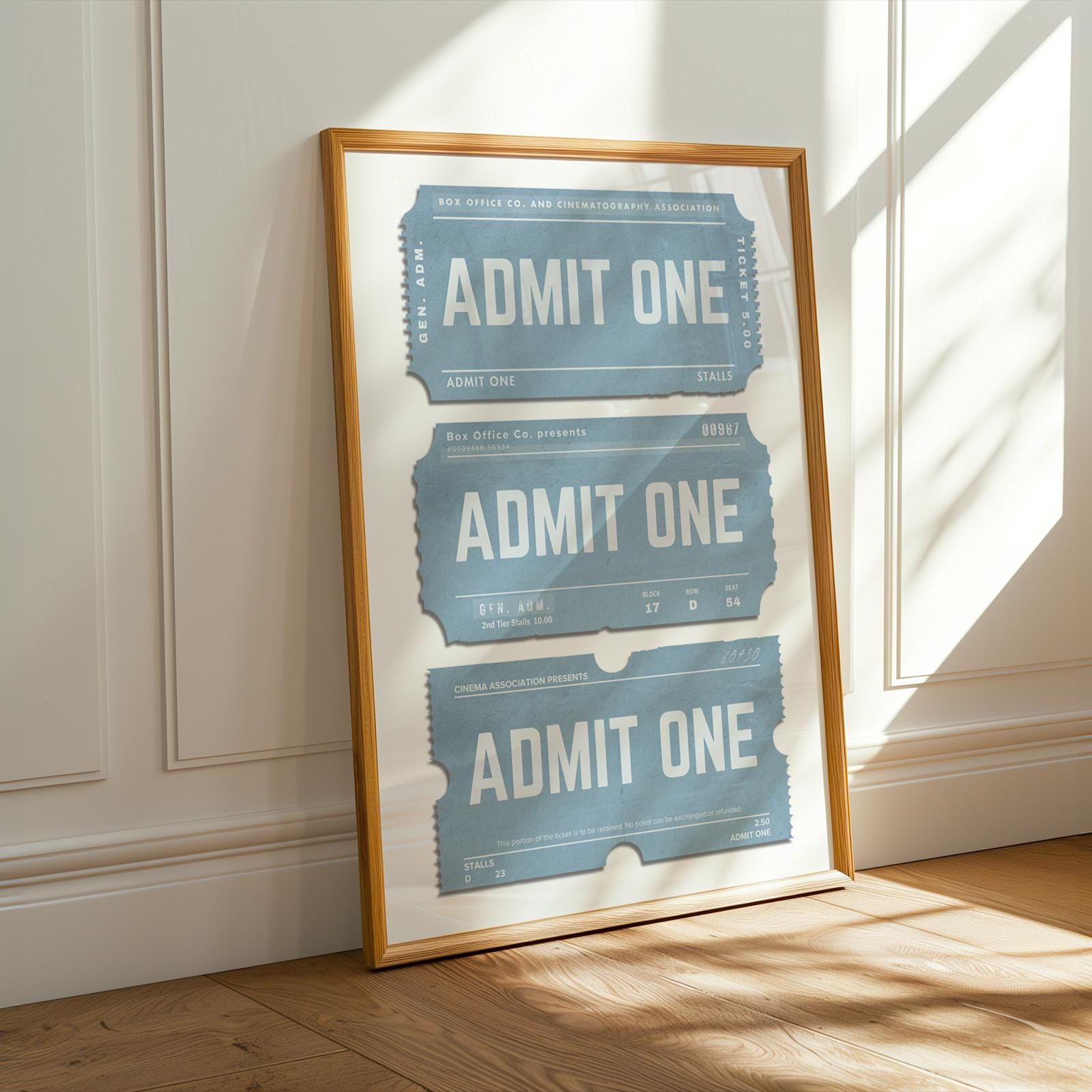 a oak framed poster in a blue colour with old worn event tickets for cinema or concert.