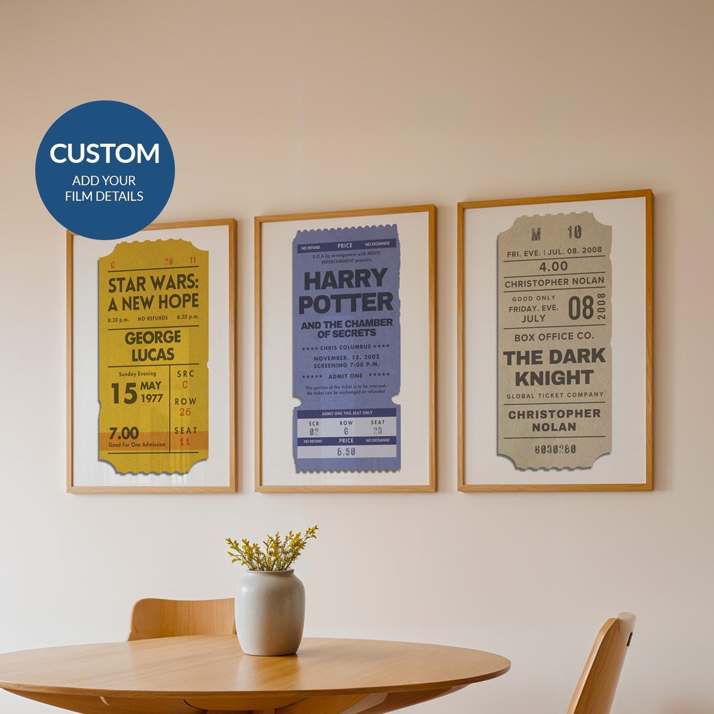 a set of 3 framed posters on wall in dining room. blue, yellow and beige retro coloured single ticket stub designs with personalised film details.