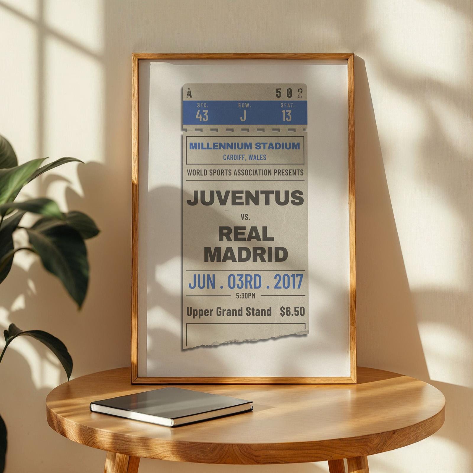 an example of a personalised football vent pass. In an oak frame leaning on a coffee table.