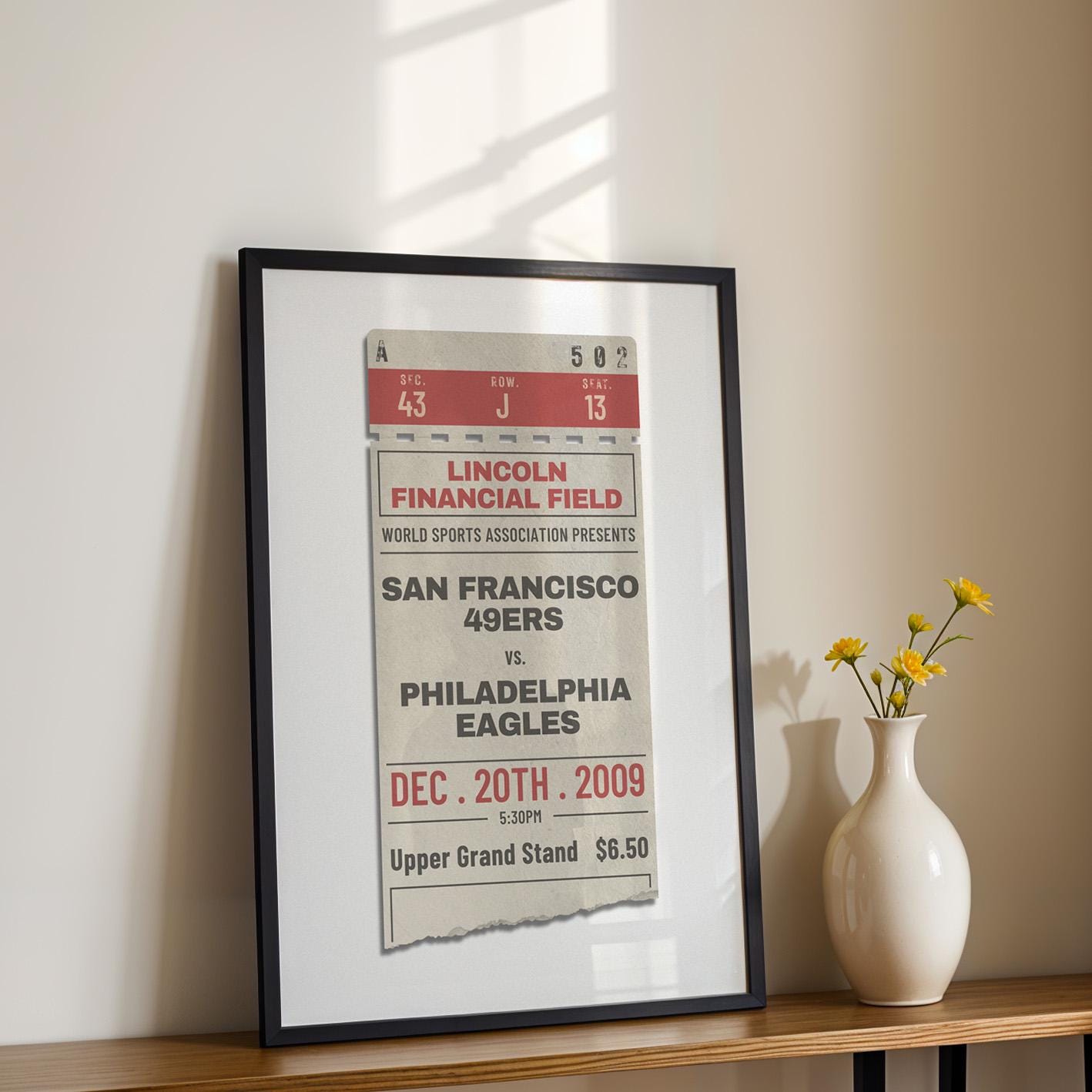 a patriotic stadium sports fan home decor piece. black framed wall art on a shelf in office.