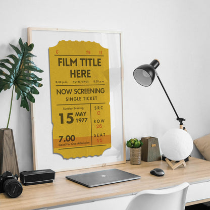 A framed poster displaying a vintage-style cinema ticket. This is seen on a man desk at home.