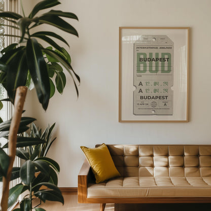 large plant in home next to white wall with beige luggage tag framed hung up