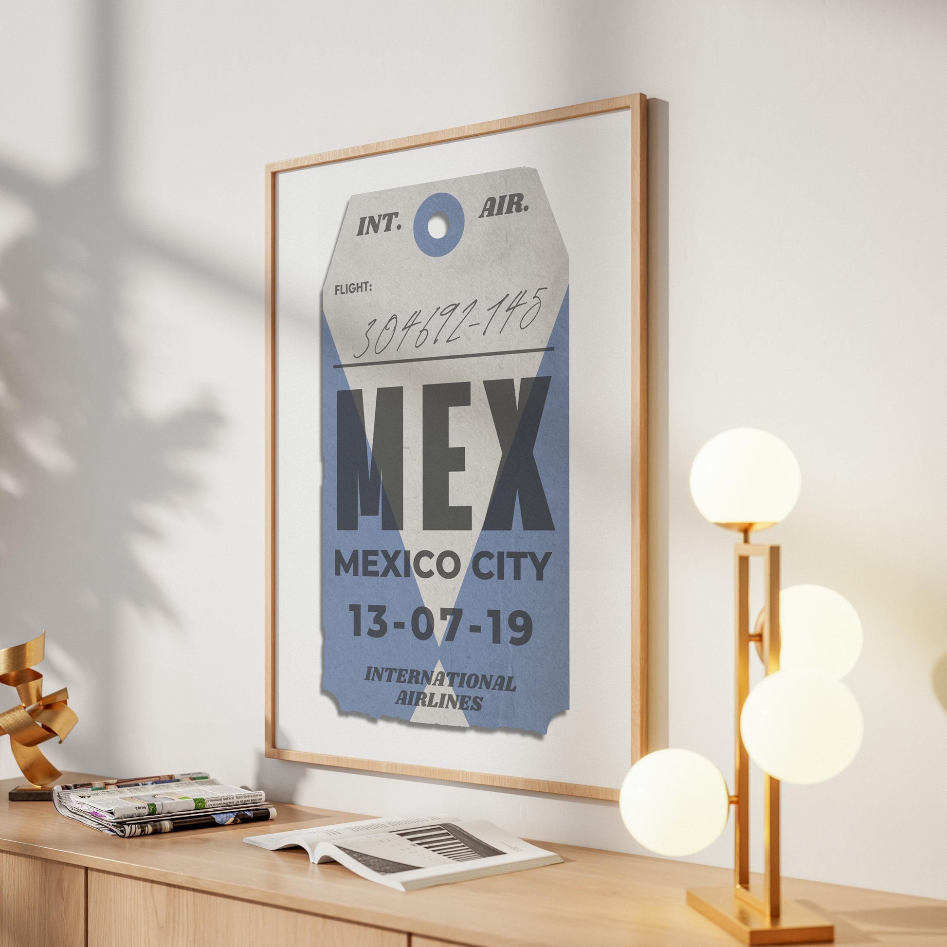 Blue luggage tag digital poster leaning on shelf, bespoke and personalised travel gift for holiday flights and memories.