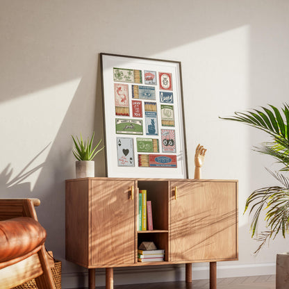 A lucky charm art piece framed on the wall. A way to display our digital file download once printed. Positioned in a cosy living room on a wooden cabinet.