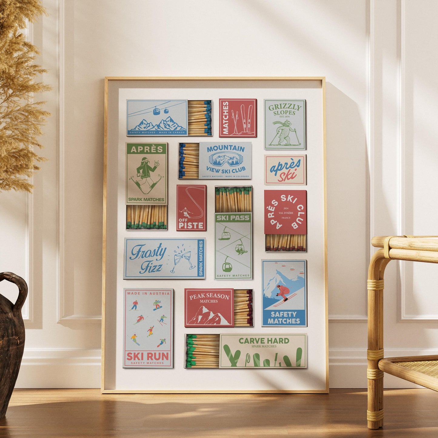 A pastel poster showcasing vintage matchbox designs with ski resort themes. The matchbooks feature illustrations of skiers, mountains, and phrases such as "Ski Run." The color scheme includes red, blue, and green.