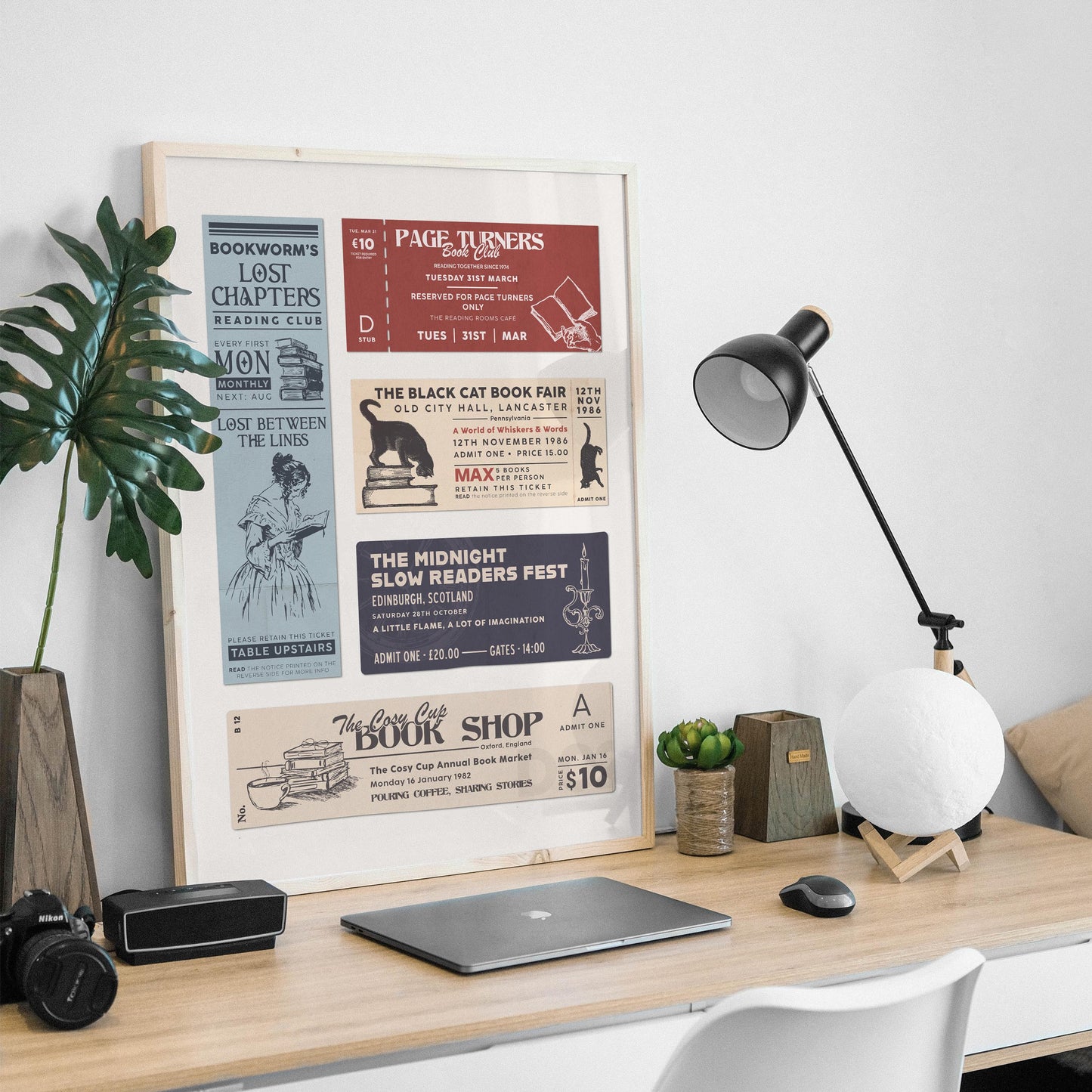 readers motif stubs on a white background on a wall art piece. on a masculine office desk with a lamp and plant.