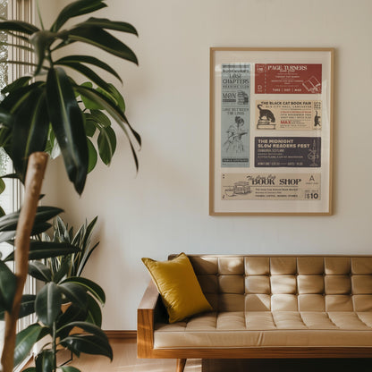 A wood framed print displaying vintage tickets for bookish-related events. The print includes text such as  "The Black Cat Book Fair". The frame is made of light-coloured wood hung in a living room with a brown leather sofa.
