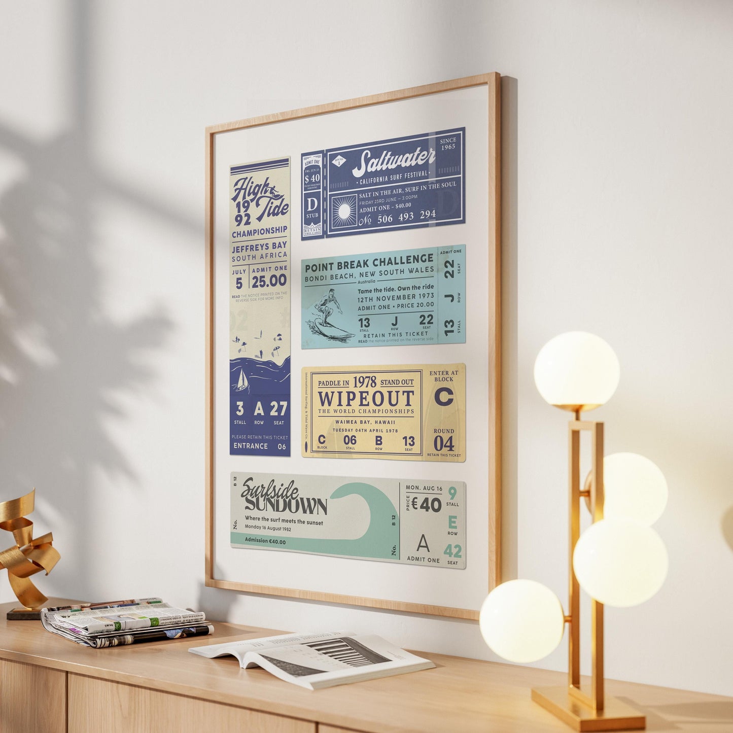 A bright modern home hallway with a ocean surfing old school stub print hung on the wall. A stylish lamp is also on the sideboard.