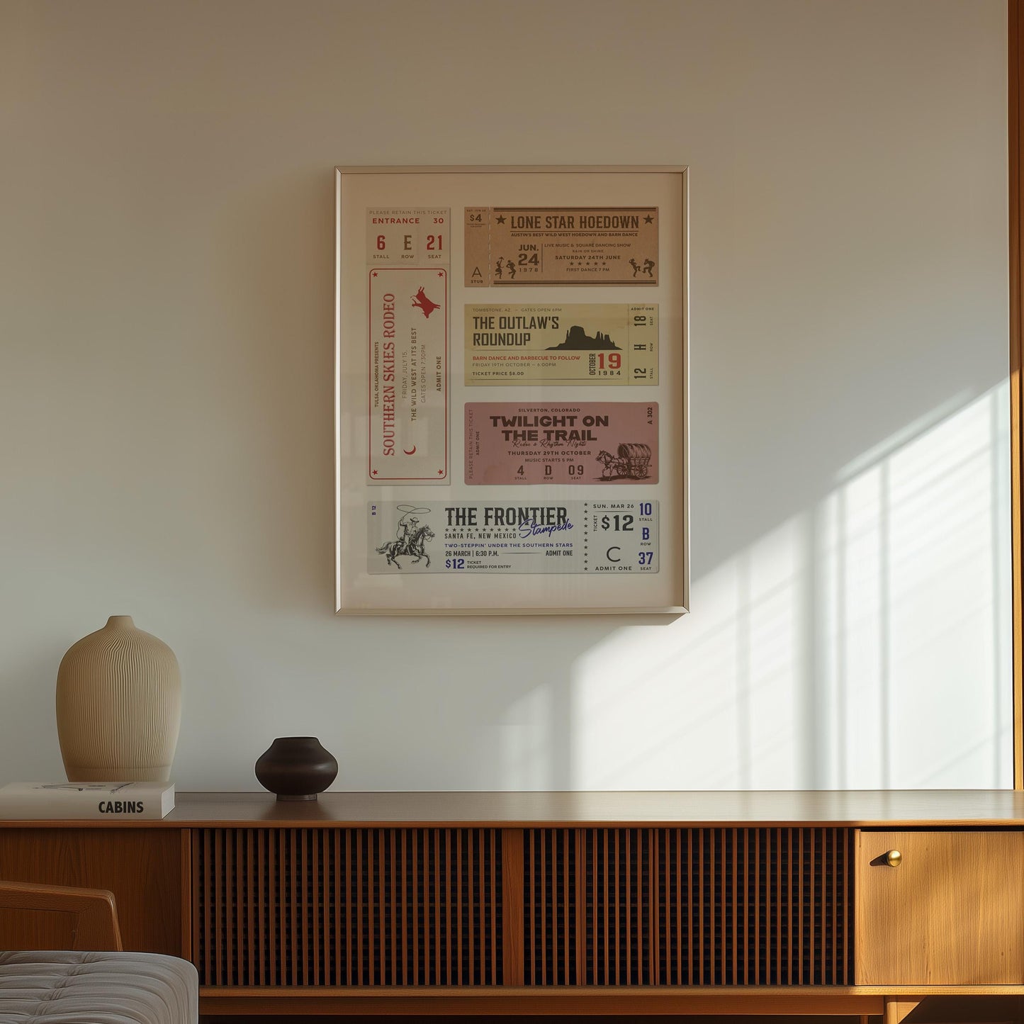 A dark wood tv unit with minimalist vases on top. A pastel rustic tone cowboy ticket print is on the wall above.