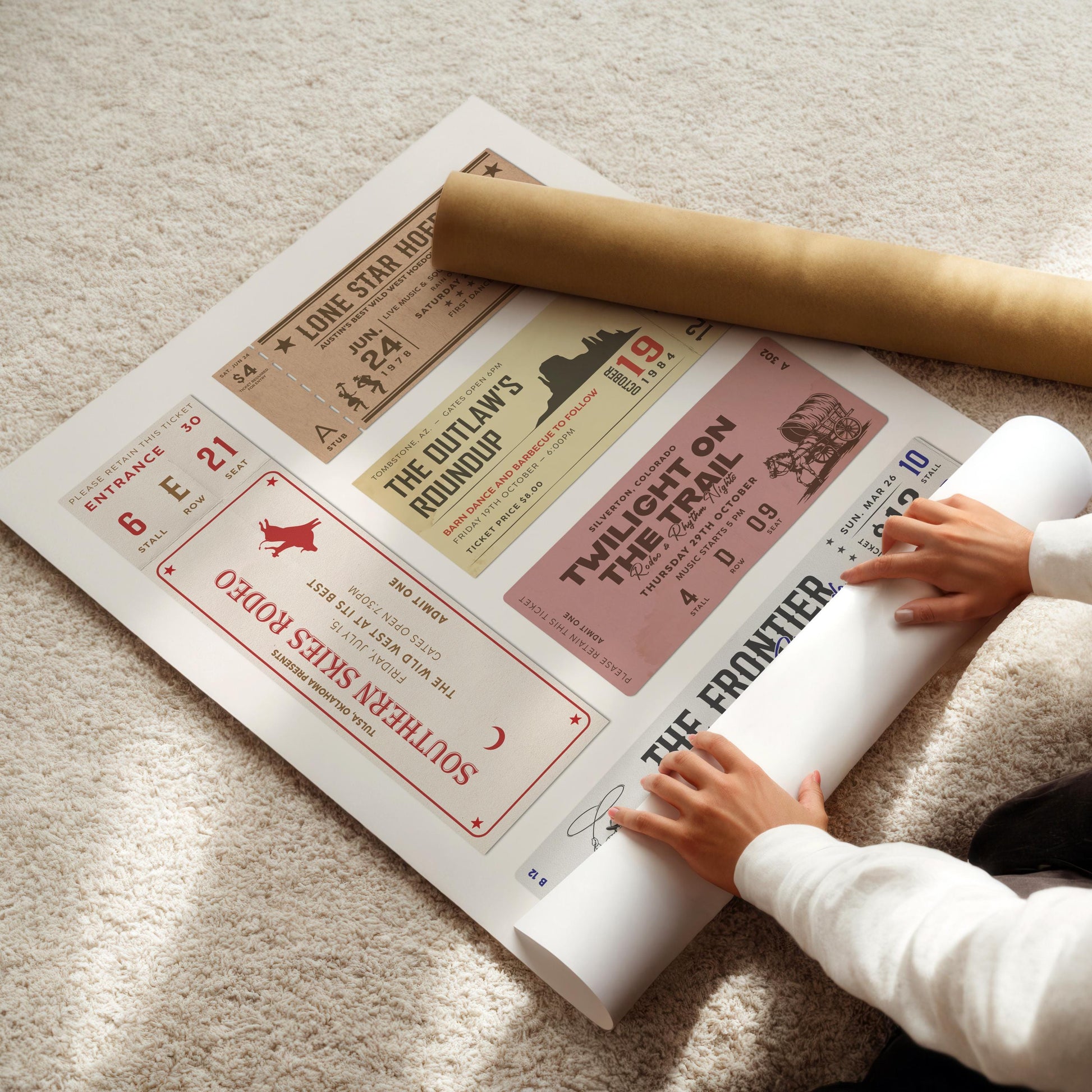 trendy aesthetic printable cowboy and cowgirl art being rolled out on a cozy carpet.