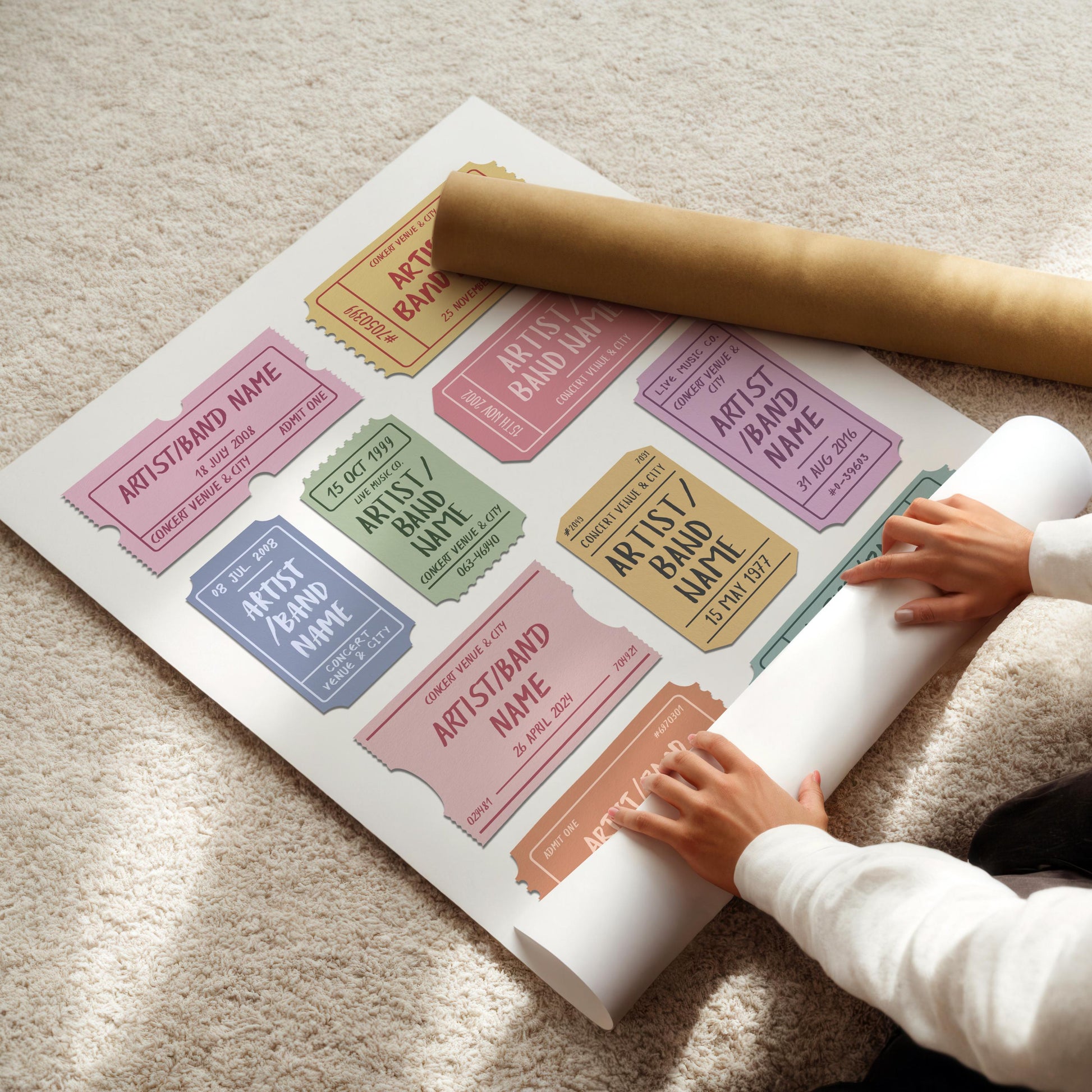 Live music wall art with vibrant vintage entry pass stubs is being rolled out on the floor in a cosy home