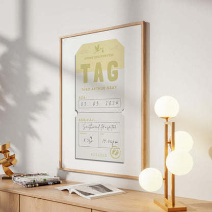 A modern home entryway with a large print on the wall showing a reto airport tag art with newborn stats on it.
