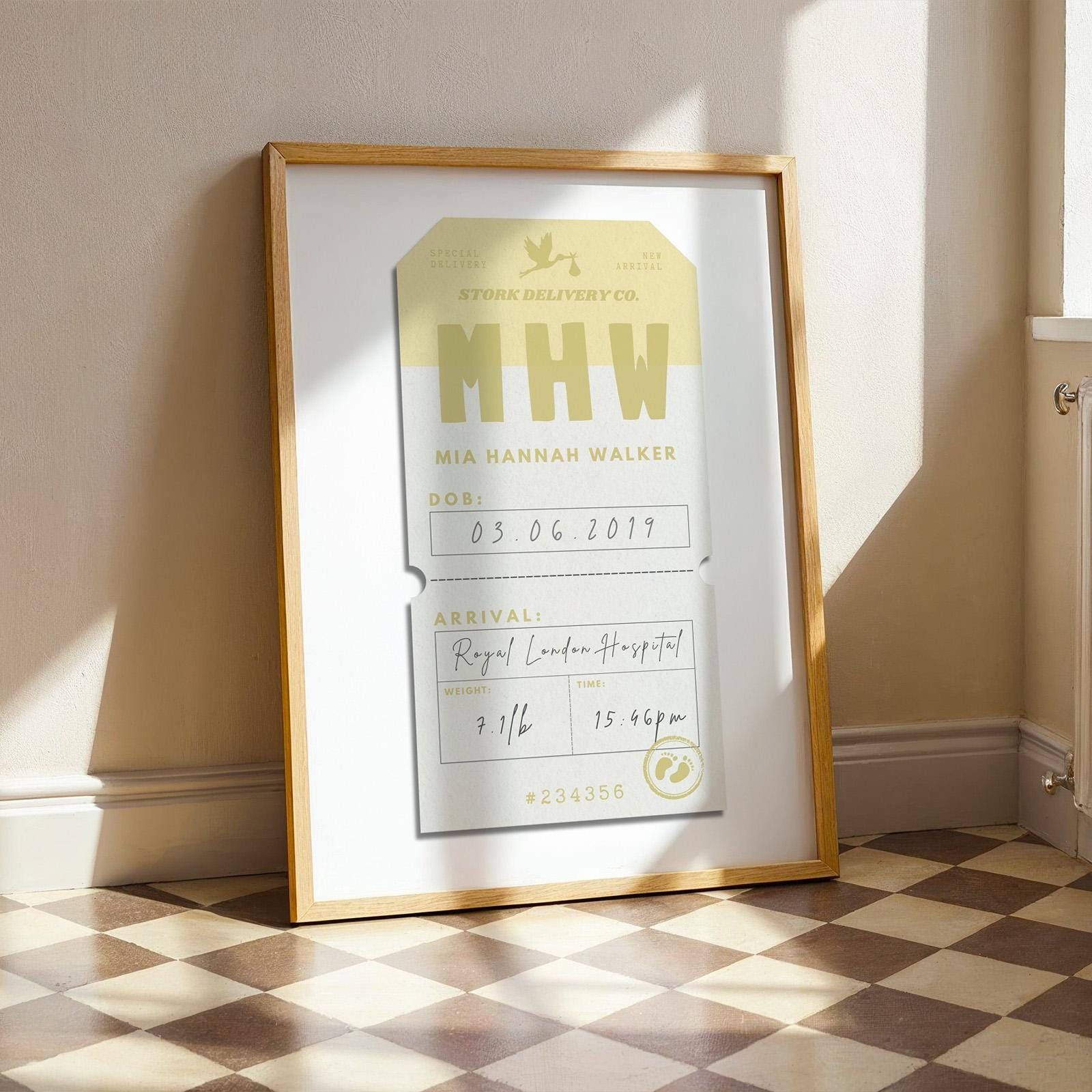 A pastel yellow colour unique baby announcement wall decor for new parents. The art shows handwritten details and bold text to replicate an arrivals airport travel tag.