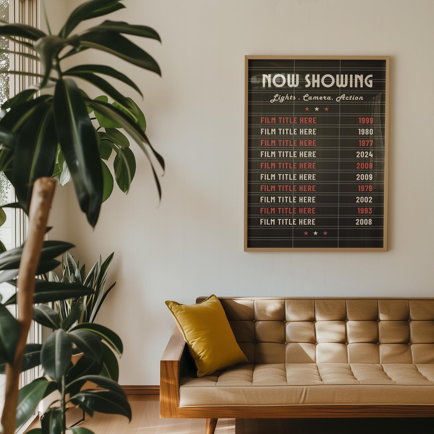 A retro apartment with a poster hung on the wall above a leather sofa. The art is a black letterboard style cinema lover wall art piece.