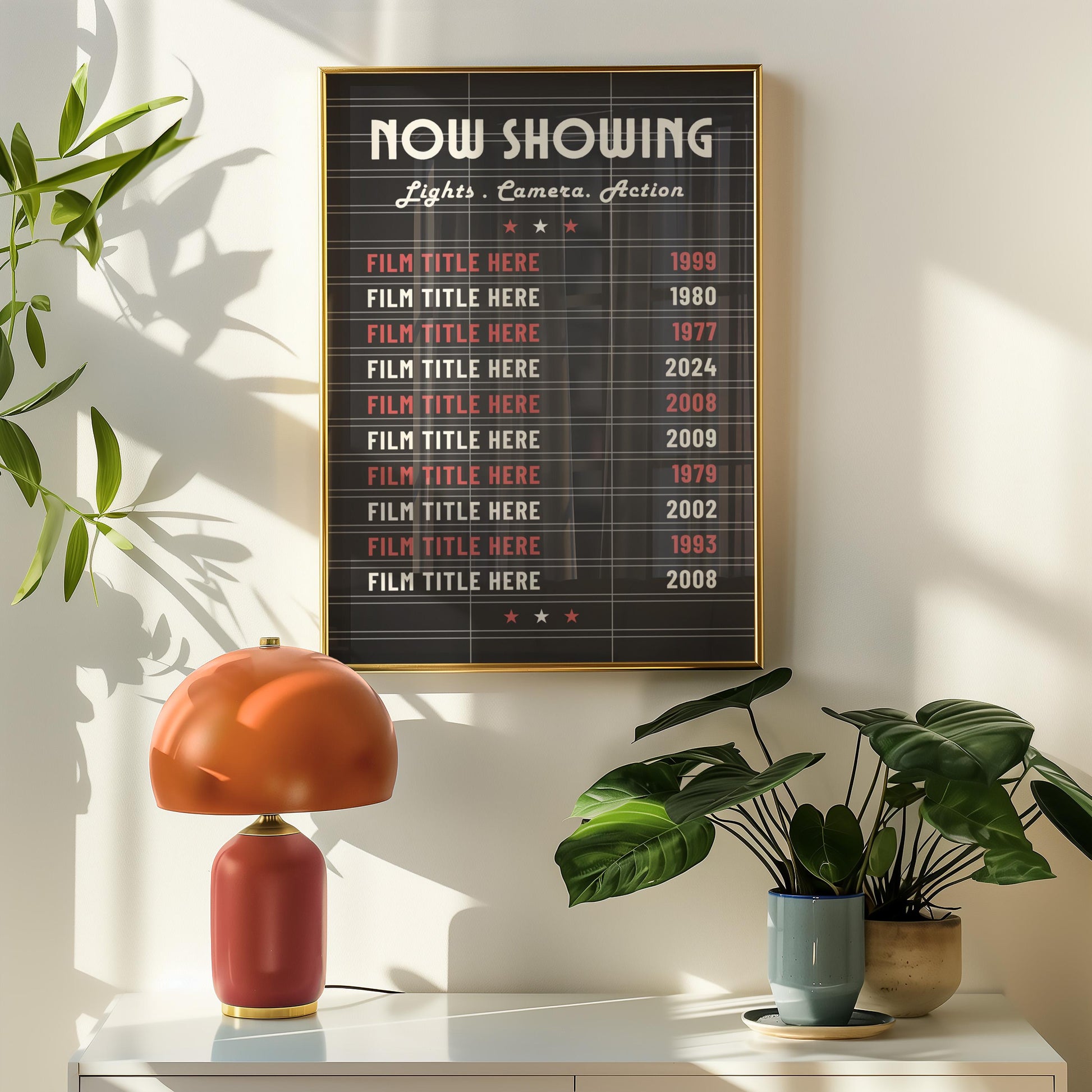 A retro hallway with a orange lamp and plant on a sideboard. Above is a black lightbox inspired cinema billboard print showing a selection of old classic films.