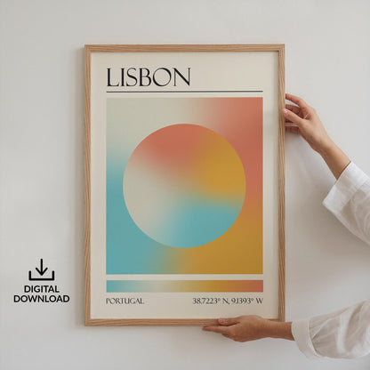 Someone in a white top holding up a framed print on the wall. The art is a destination travel poster inspired by spiritual aura colours inspired by the location such as Lisbon.