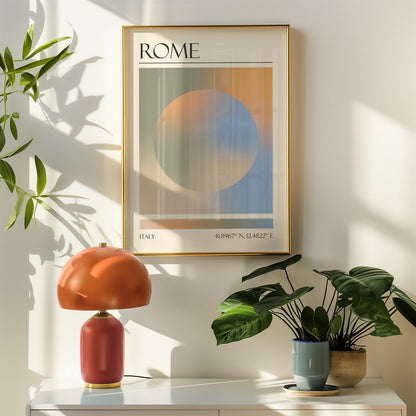 A framed travel poster featuring a geometric aura inspired design in shades of blue, orange, green and beige hangs above a orange table lamp. Potted plants are on the right.