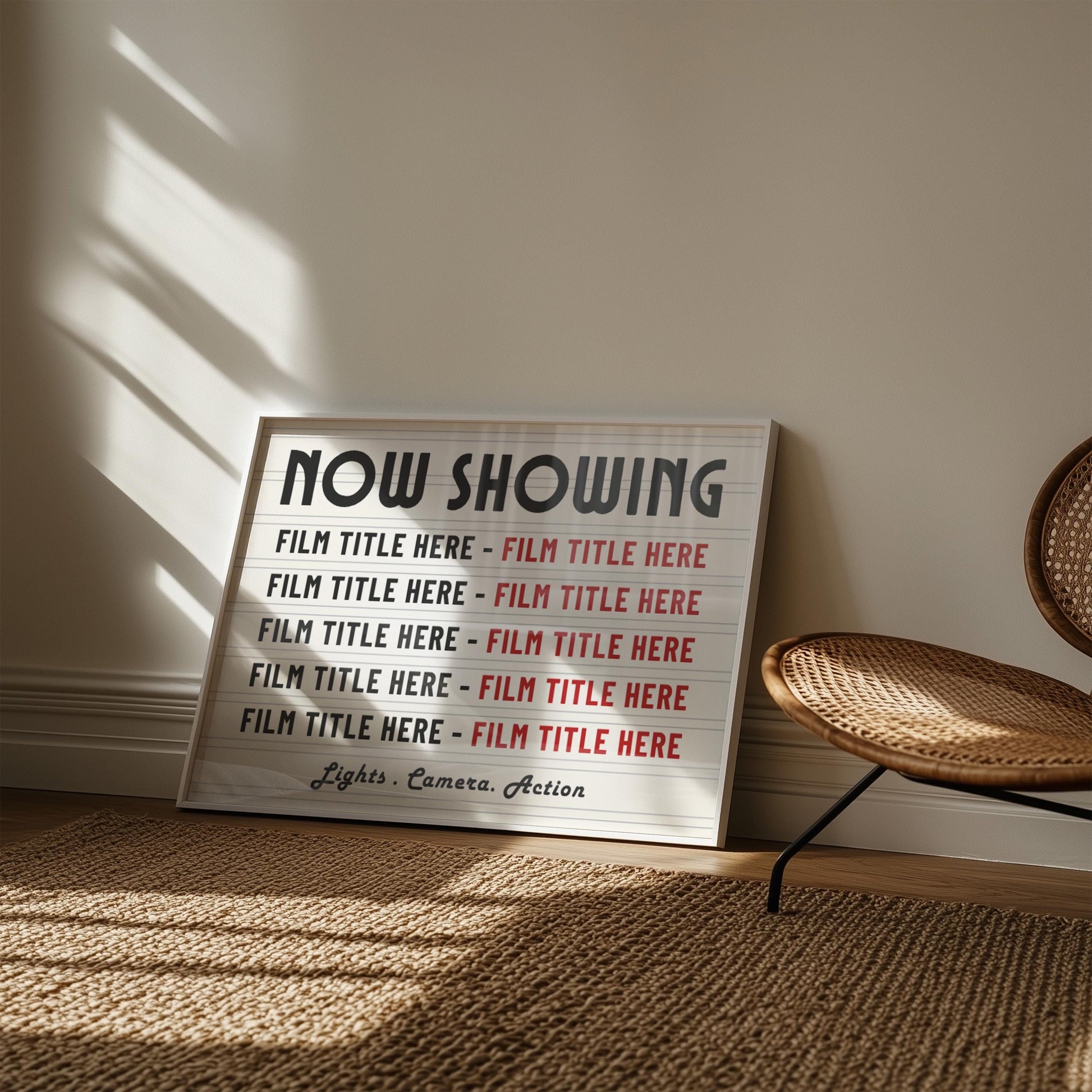 A cosy bedroom with a rattan armchair and rug. Leaning on the wall is a horizontal white frame with a marquee inspired cinema print with 10 personalised film titles.