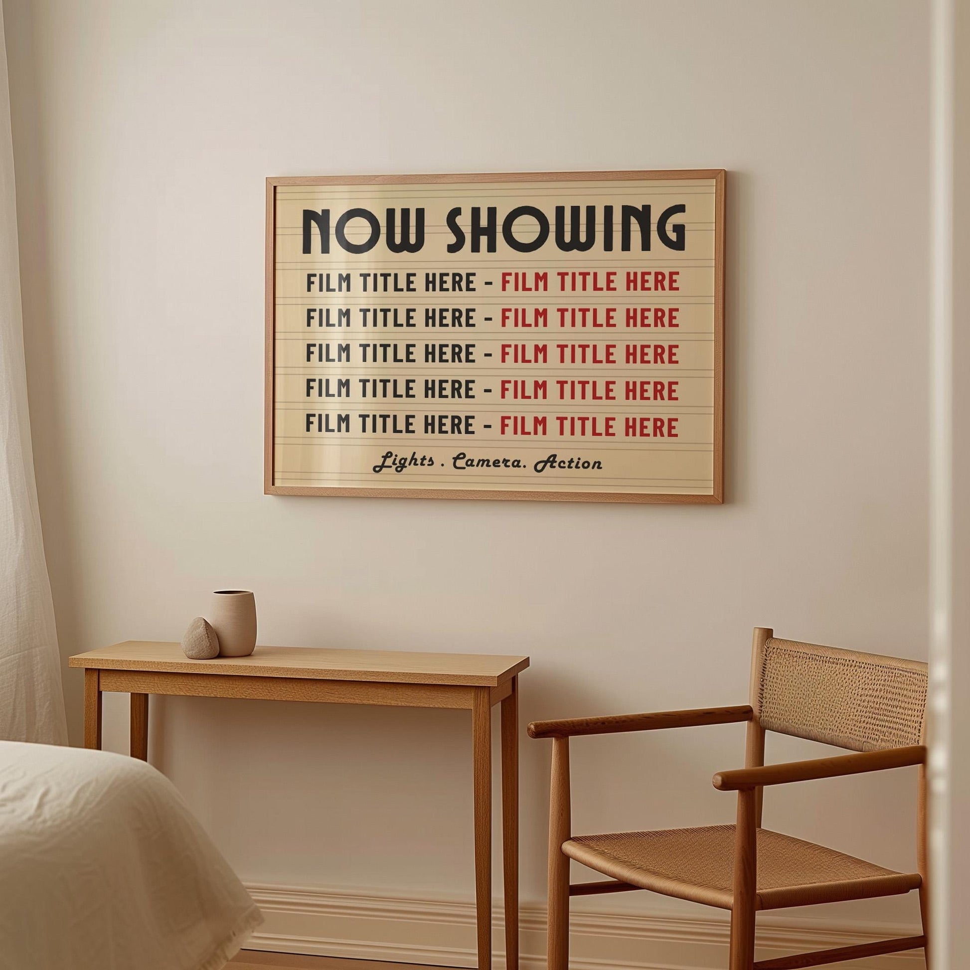 A bedroom with soft rattan and wood furniture featuring a large horizontal framed print. The print is a vintage yellow colour with marquee style details showing 10 personalised film titles chosen by the gift recipient.