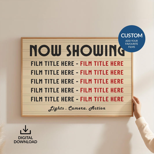 A person holding up a large framed landscape vintage movie print, customised with up to 10 bespoke film titles.
