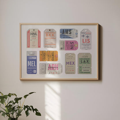 A landscape framed art print hung on a white wall. The poster has vintage luggage tickets on it in colourful schemes showing unique travel places with dates and airport codes.