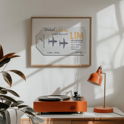 A home living room with a record player and orange lamp. On the wall is a keepsake style flight tag with a retro beige colour old tag