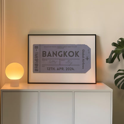 A minimalist home with a large landscape gallery wall piece near a warm light. The art has vintage details inspired by a retro luggage tag