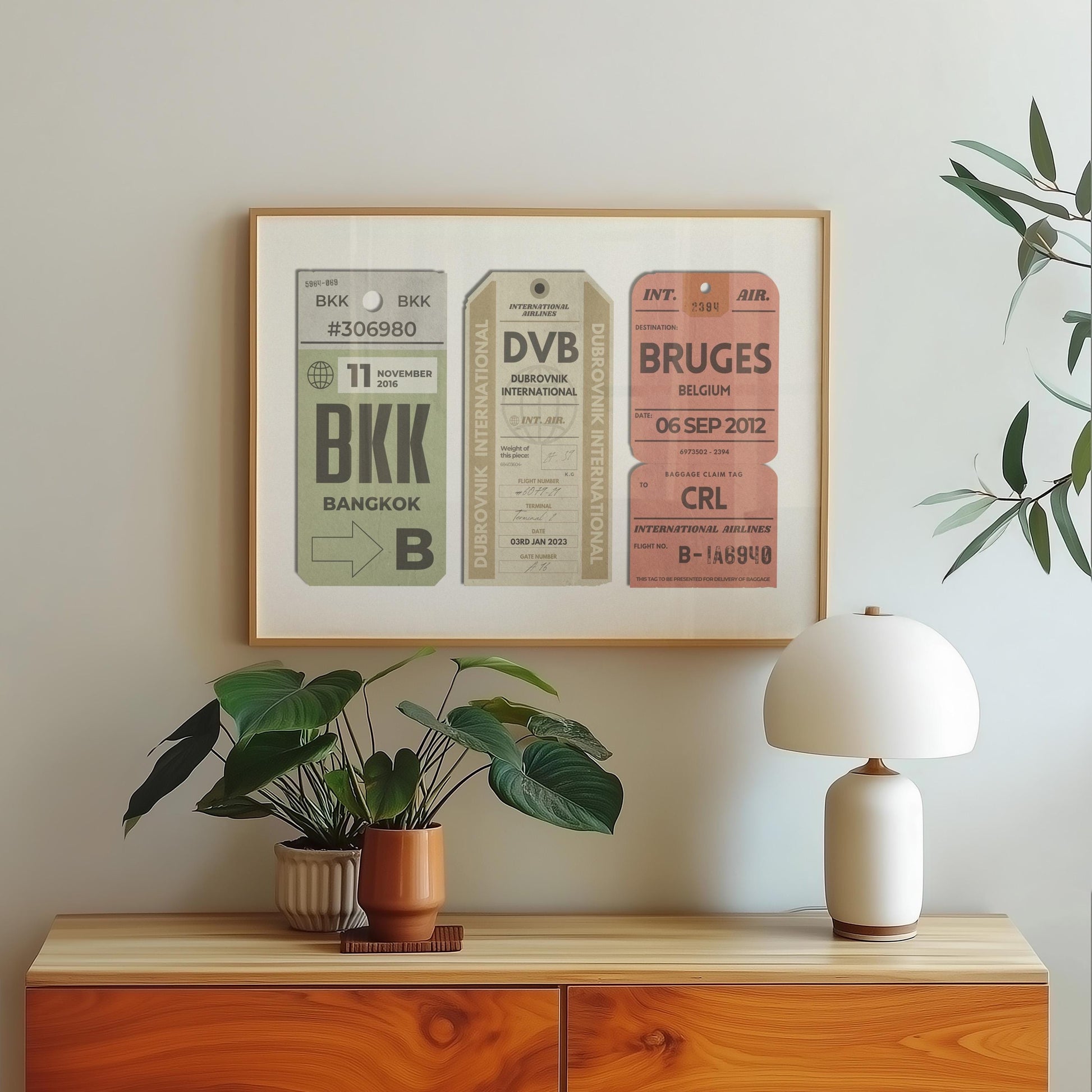 A wood dressed with a lamp plant and poster hung on the wall above. The art is of aviation tags from an airport with plane graphics, rustic edges and worn details like an old ticket.