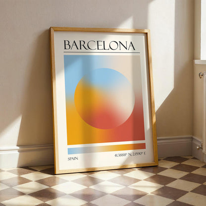 A framed print with the word "BARCELONA" at the top. The modern location artwork features orange and teal in an abstract style as colours of Barcelona. The bottom of the print reads "SPAIN" and includes coordinates.