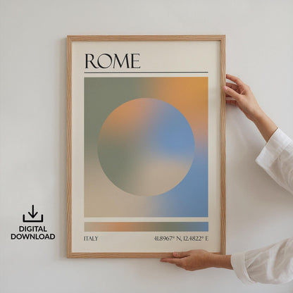 Someone in a white top holding up a framed print on the wall. The art is a destination travel poster inspired by spiritual aura colours inspired by the location such as Rome.