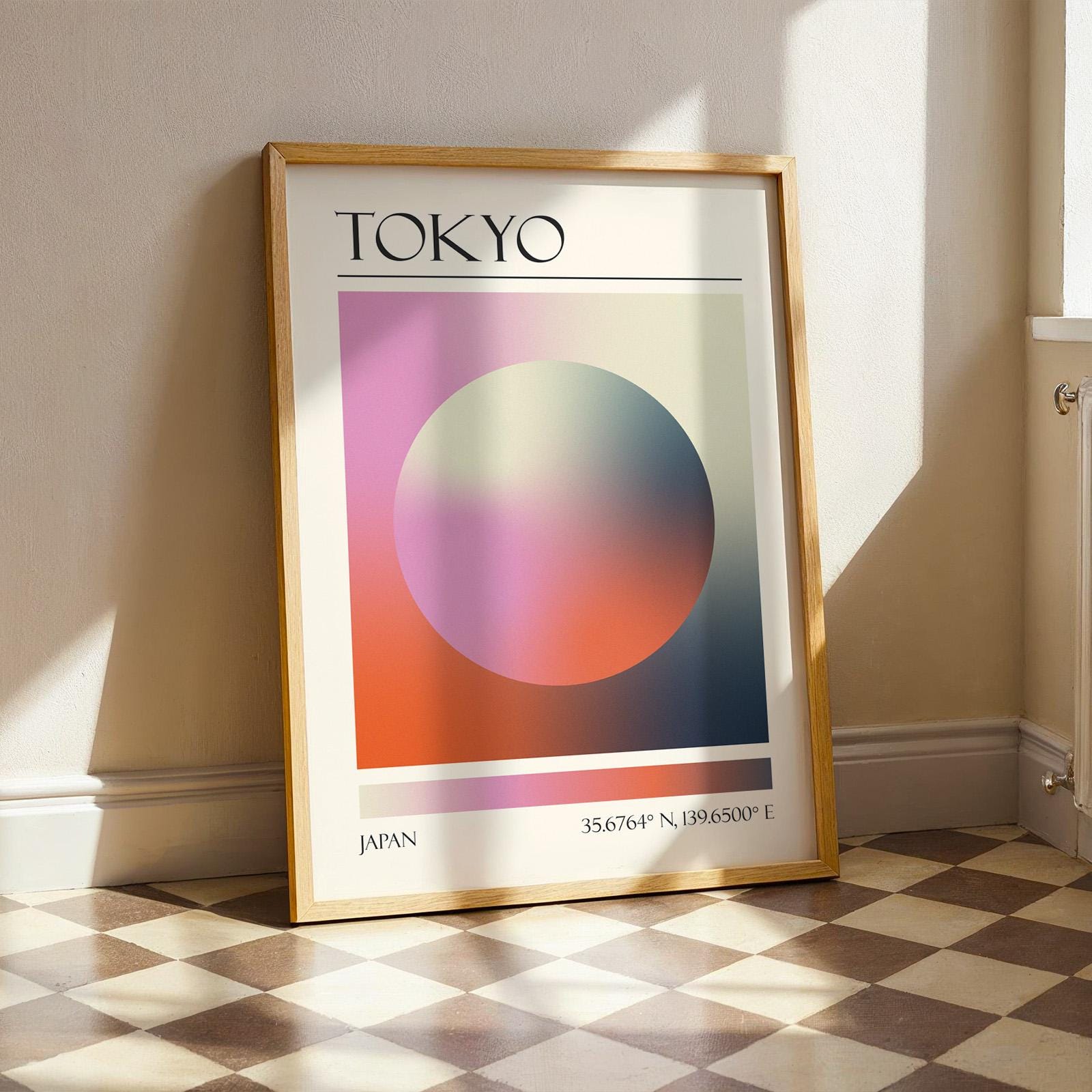 A framed print with the word "TOKYO" at the top. The modern location artwork features orange, pink and black in an abstract style as colours of Tokyo. The bottom of the print reads "JAPAN".