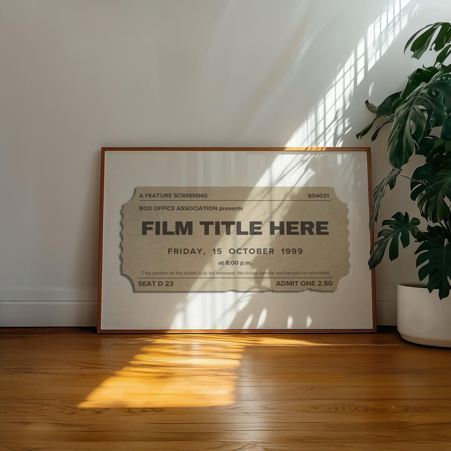 A well lit hallway with a poster leaning on the wall in a wood framing. The poster shows a designed old movie theatre stub with a bespoke film title on it.