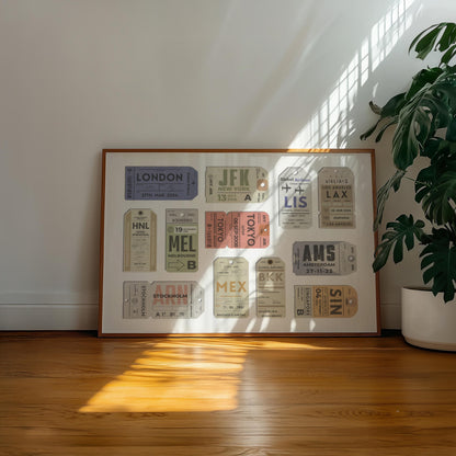 A well lit Livingroom with warm wood floor and a large horizontal frame leaning on the wall. The art is eclectic and bespoke made from city travel destinations