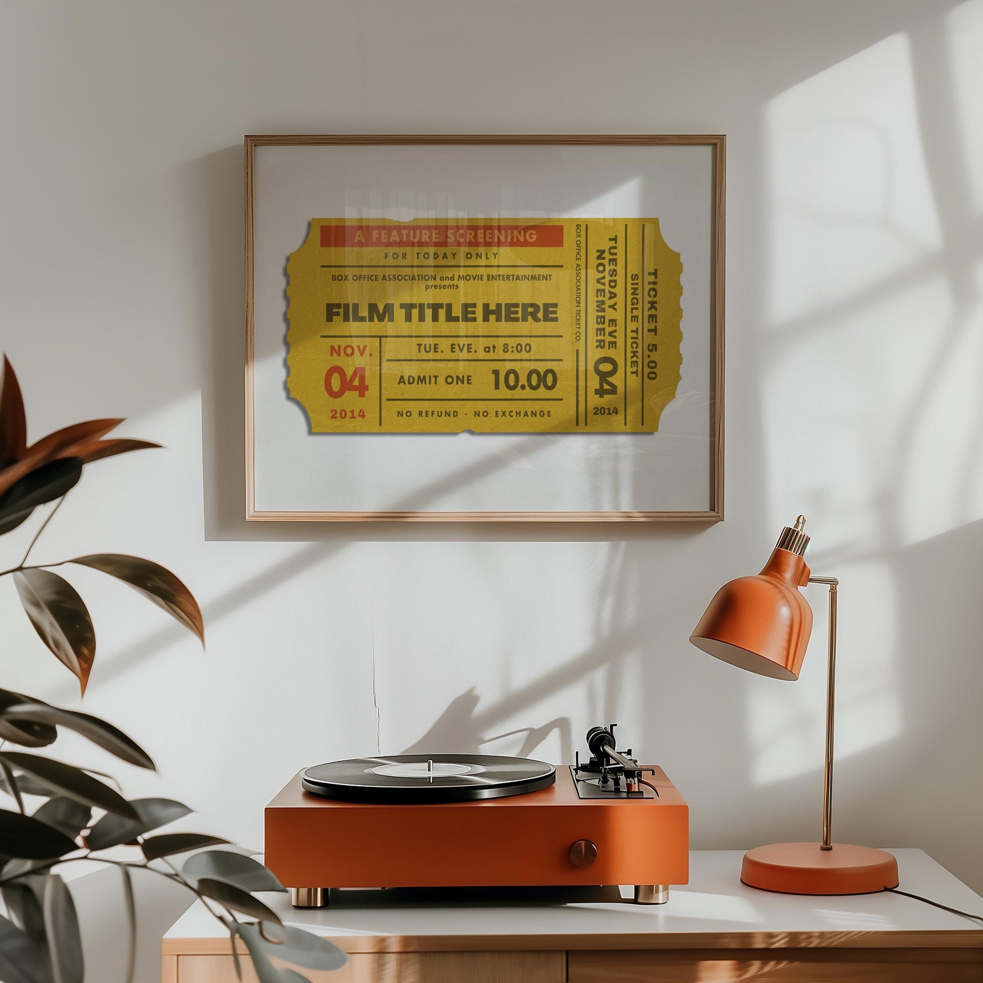A retro home decor with a record player and industrial style lamp. Art hung on the wall above is eclectic, vintage and sentimental