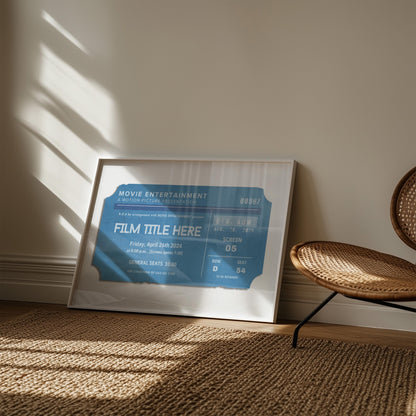 A navy muted blue framed film print leaning on the wall in a natural vibe bedroom.