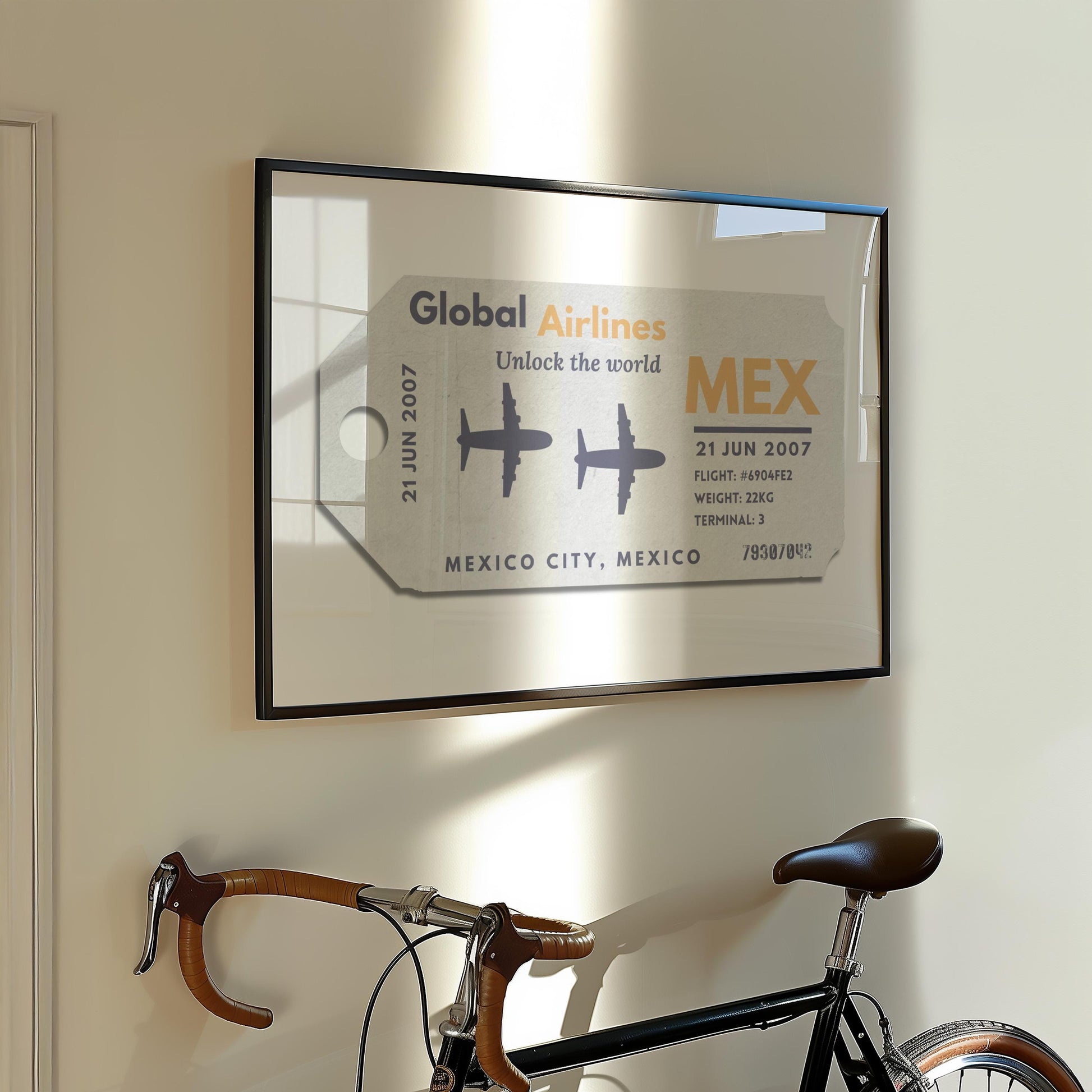 A Parisian flat hallway with a bike leaning on the wall and a framed print hung on the wall. The art is a personalised keepsake of a luggage tag with custom details on it